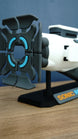 Angled front view of Subnautica 2 Sonic Resonator replica showing the large segmented emitter array, white body and included black display stand