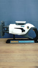 Subnautica 2 Sonic Resonator replica displayed side-on with white and grey body, cyan and orange details, and included collector display stand