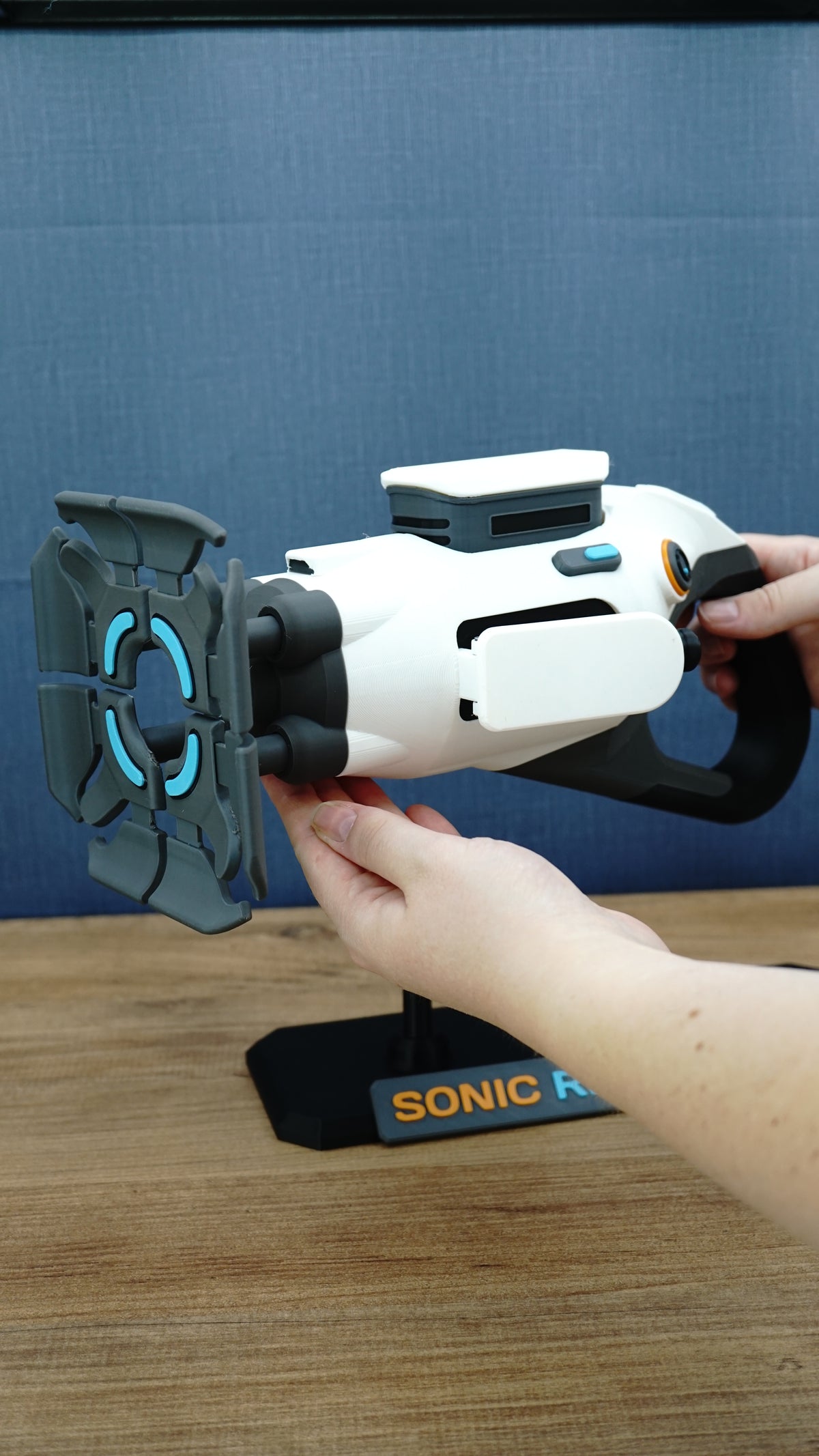 Subnautica 2 Sonic Resonator replica being held to demonstrate its large display scale, with front emitter, rear grip and collector stand visible