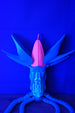 Collector Leviathan display figure glowing under blue UV light with open head crest, wing-like fins, and long poseable tentacles
