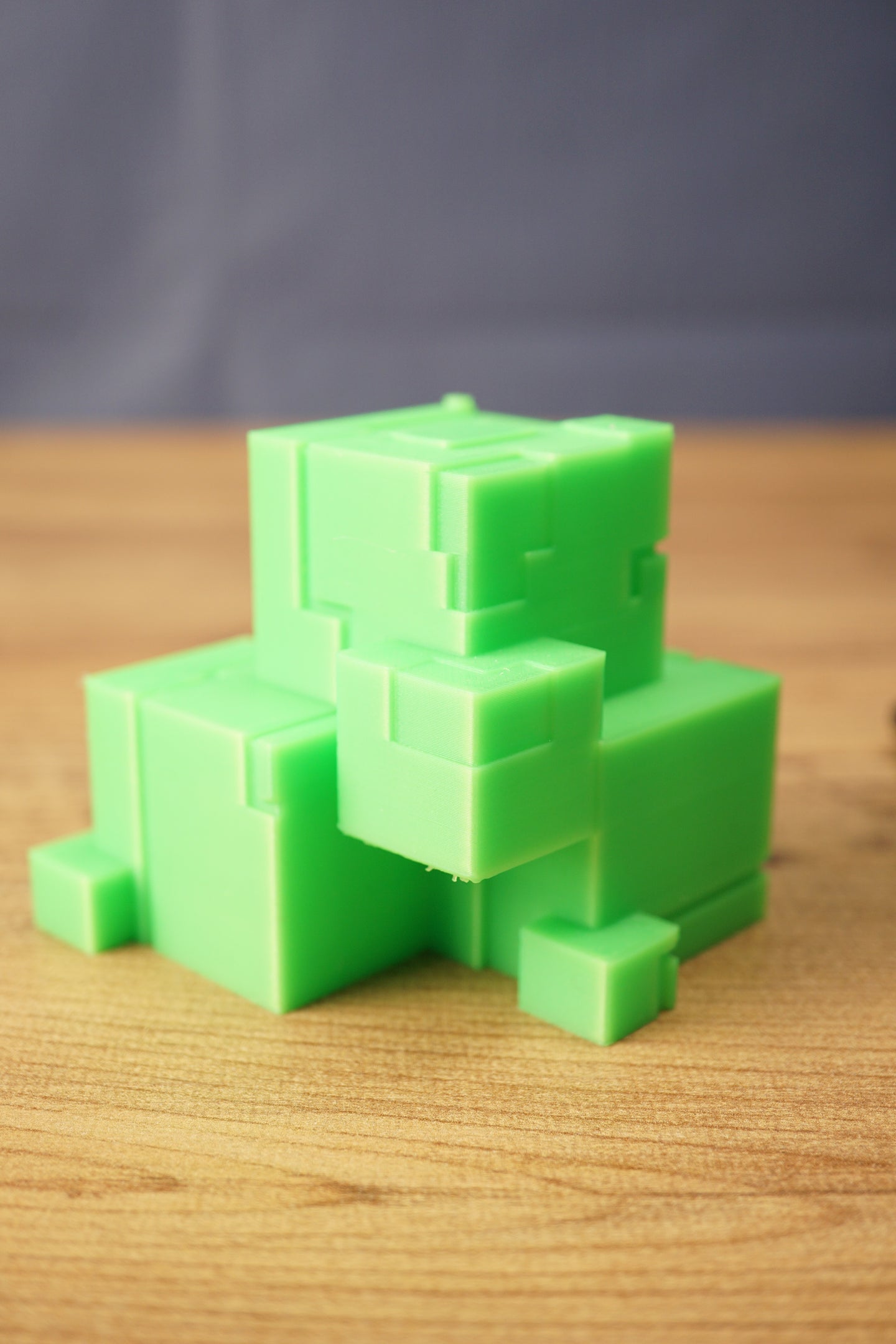 Close-up angled view of a green Subnautica ion cube replica, highlighting the raised block pattern and geometric collectible design.