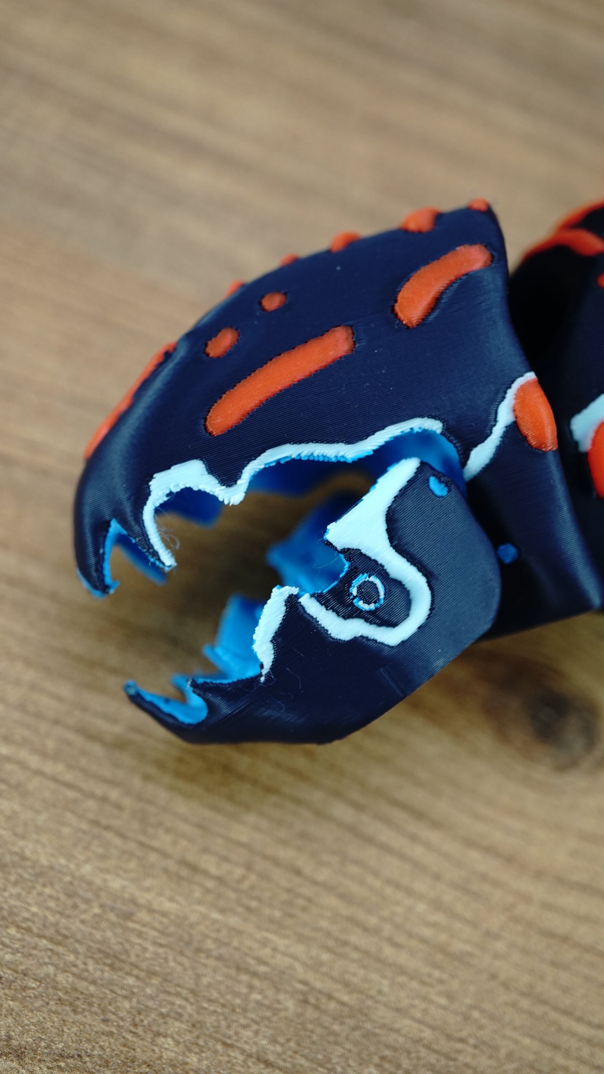 Close-up of the articulated Marrowbreach figure’s open mouth with blue jaw details, white edging, and orange markings on a dark blue head.