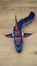Top view of an articulated Subnautica Marrowbreach figure showing orange markings along the head, dorsal fin, side fins, and segmented body.