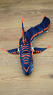 Top view of an articulated Subnautica Marrowbreach figure showing orange markings along the head, dorsal fin, side fins, and segmented body.