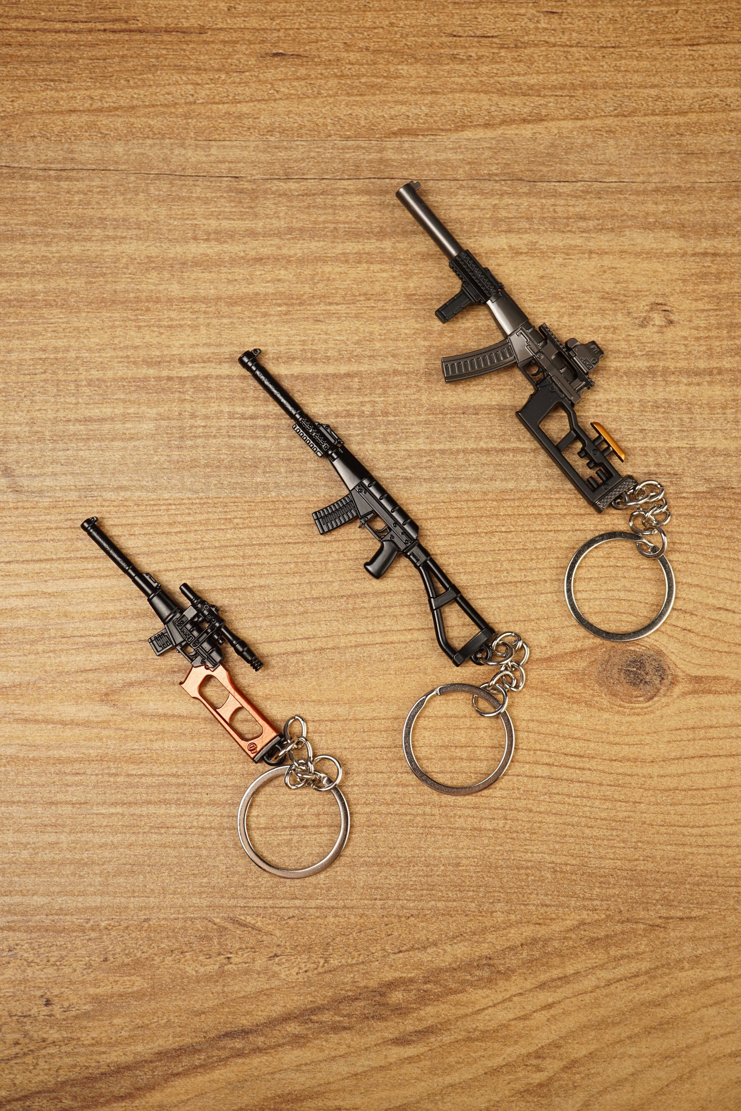 Set of three tactical rifle keychains arranged diagonally, featuring VSS Vintorez and AS Val inspired gamer collectible designs