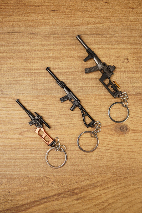 Set of three tactical rifle keychains arranged diagonally, featuring VSS Vintorez and AS Val inspired gamer collectible designs