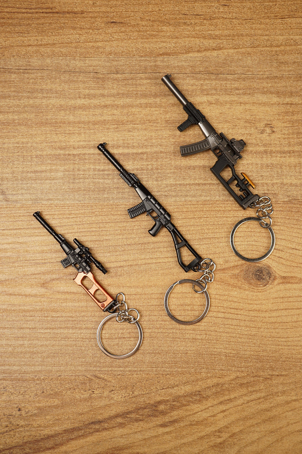 Set of three tactical rifle keychains arranged diagonally, featuring VSS Vintorez and AS Val inspired gamer collectible designs