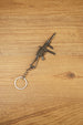 Angled view of a detailed UMP45-style tactical submachine gun keyring with metal chain, suppressor-style barrel and front grip