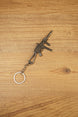 Angled view of a detailed UMP45-style tactical submachine gun keyring with metal chain, suppressor-style barrel and front grip