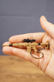Tan tactical rifle keyring with black optic, stock and barrel details resting in hand, a compact collectible gift for shooter game fans