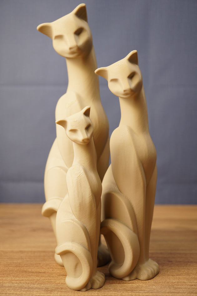 Set of three beige 3D printed cat figurines inspired by Tarkov, displayed together on a wooden tabletop with a grey backdrop.