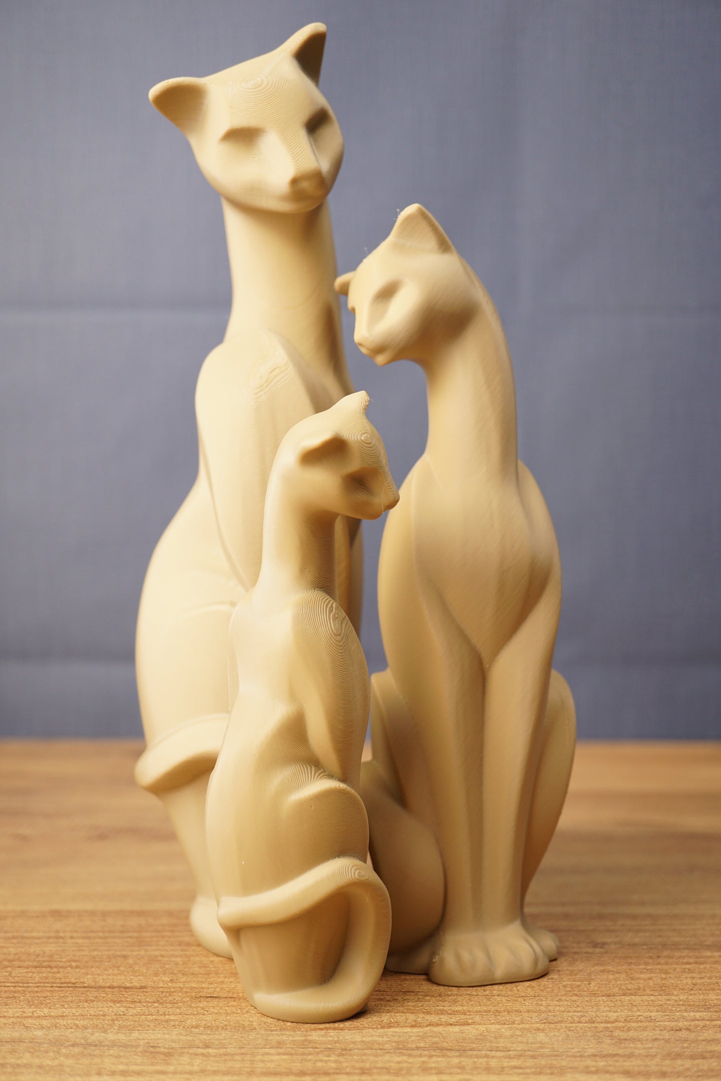 Grouped Tarkov inspired cat figurine replicas with smooth beige finish, elegant seated poses, curved tails, and sculpted facial details.