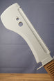 Close-up of a gray 3D-printed machete replica blade, showing serrated detailing, circular cutouts, and raised center ridge.