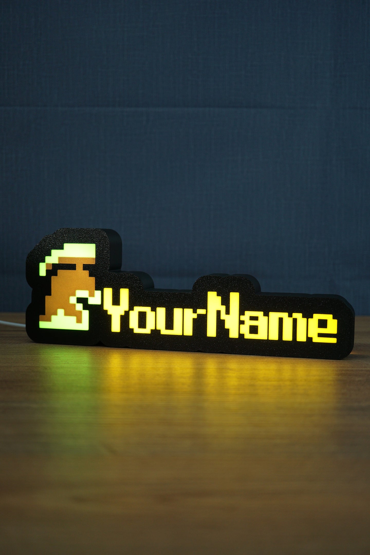 Illuminated unranked group ironman nameplate glowing in the dark with green and grey helmet icon and bright yellow personalized text.