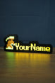 Illuminated unranked group ironman nameplate glowing in the dark with green and grey helmet icon and bright yellow personalized text.