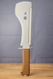 Full upright view of a 3D-printed UVSR Taiga-1 survival machete replica standing on a wooden table, featuring a gray blade and brown ribbed handle.