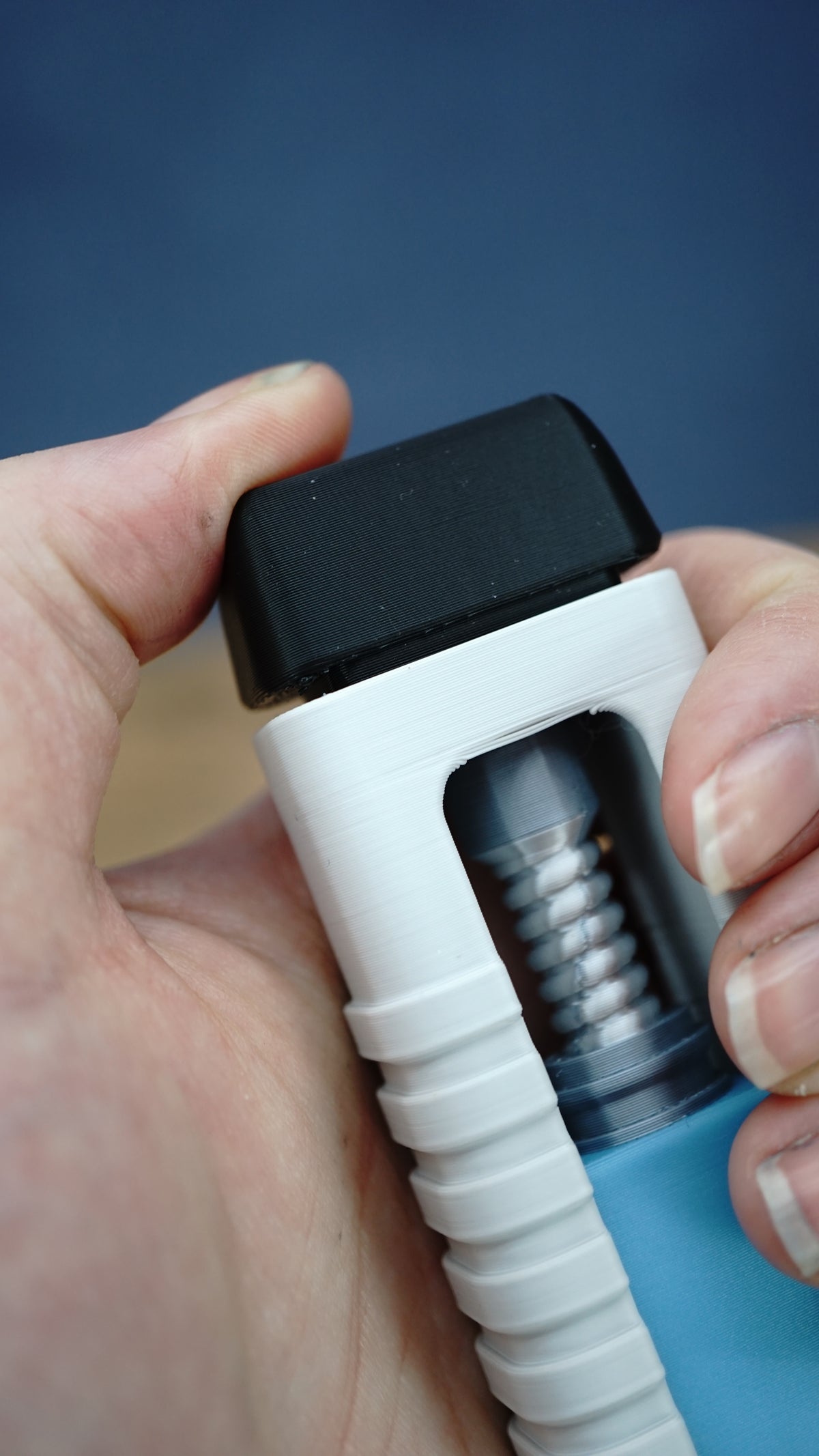 Detailed handheld close-up of the WARDOGS Adrenaline Pen replica, highlighting the black upper cap, visible silver mechanism and white ridged casing.