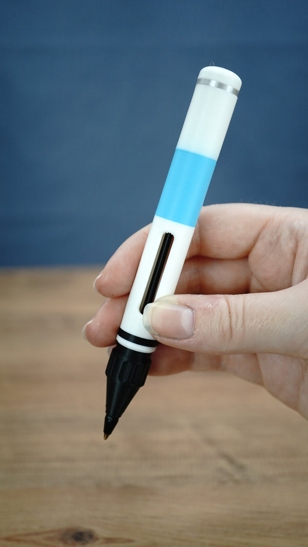 Vertical handheld view of the 14cm WARDOGS Adrenaline Stim Pen replica, featuring the white and blue casing, black grip and ballpoint tip.
