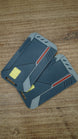 Two WARDOGS Alpha Card 1 keycard replicas stacked together, showing the futuristic grey panels, yellow chip features and red accent details.