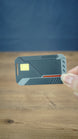 WARDOGS Alpha Card 1 replica held between fingers to demonstrate its compact 7 cm length, with the tactical-style design clearly visible.