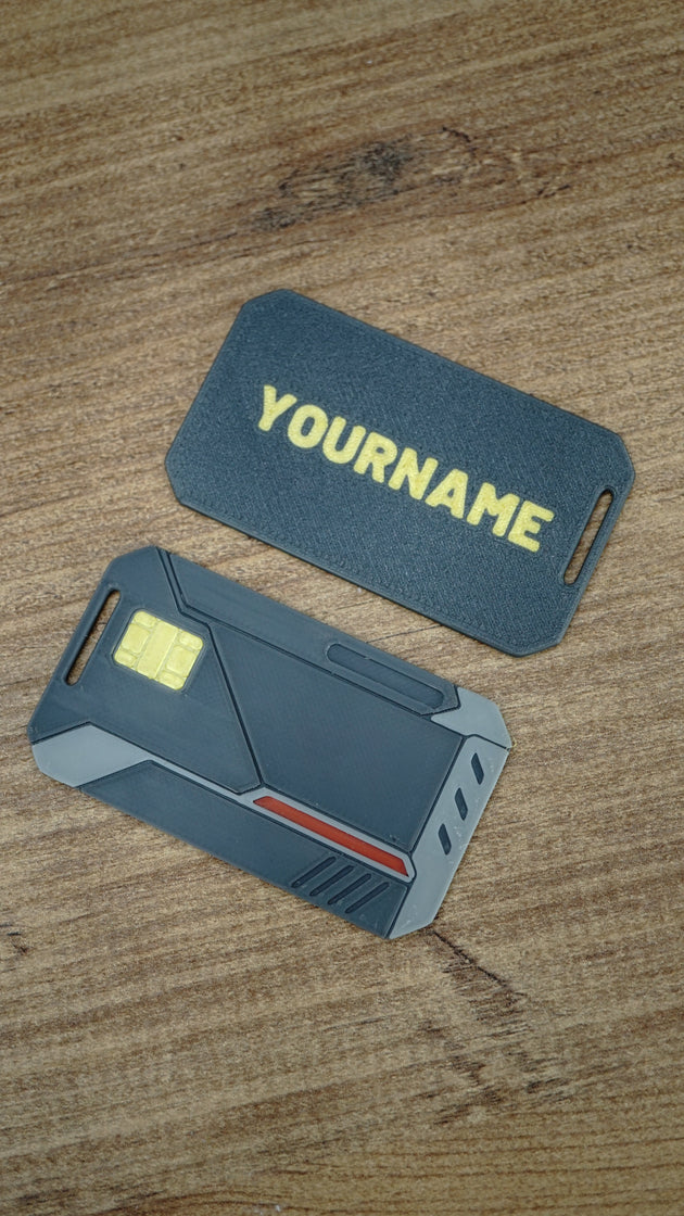 WARDOGS Alpha Card 1 keycard replica shown beside a personalised card back with yellow name lettering, featuring detailed tactical styling and grey accents.