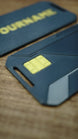 Detailed close-up of the WARDOGS Alpha Card 1 replica showing its yellow chip-style feature, dark grey body and geometric panel lines.