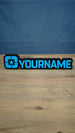 Lonestar Blue faction gaming nameplate with raised blue YOURNAME lettering, a star emblem and black backing, photographed standing on a wooden desk.
