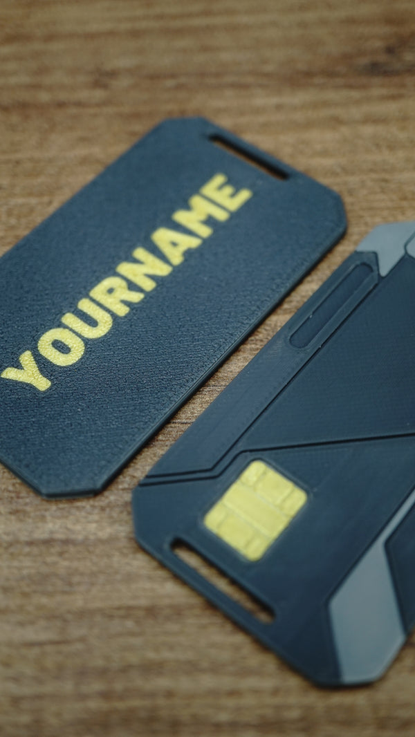 Close-up of a personalised WARDOGS Alpha Card 1 keycard showing the custom gamer name on the reverse alongside the futuristic front design.