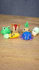 Front view of the complete Zeki’s Claw Machine Li’l Plushies miniature set arranged together on a natural wooden display surface.